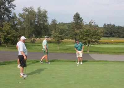 A group of people playing a game of golf.