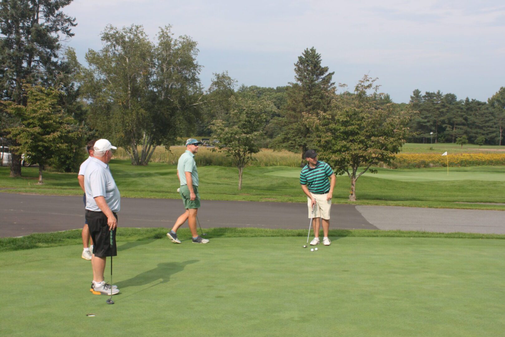 A group of people playing a game of golf.