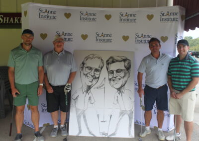 A group of men posing for a photo with a caricature.