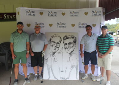 A group of men posing for a photo with a caricature.