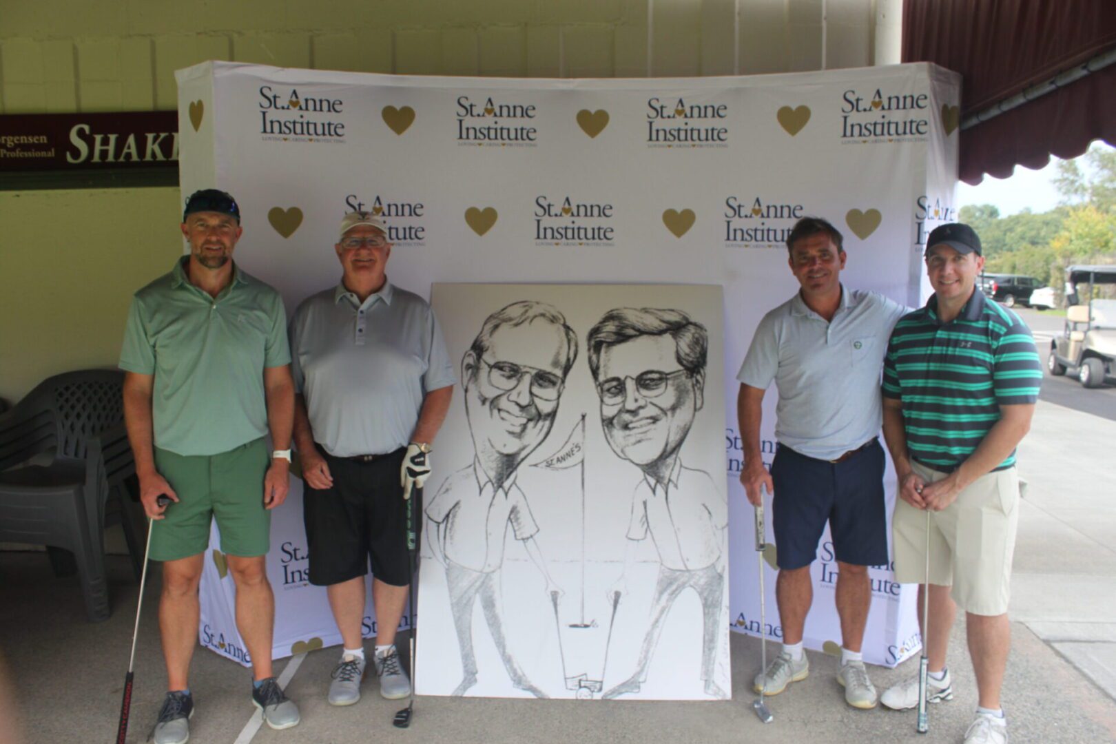 A group of men posing for a photo with a caricature.
