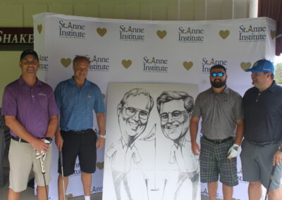 A group of men posing for a photo with a caricature.