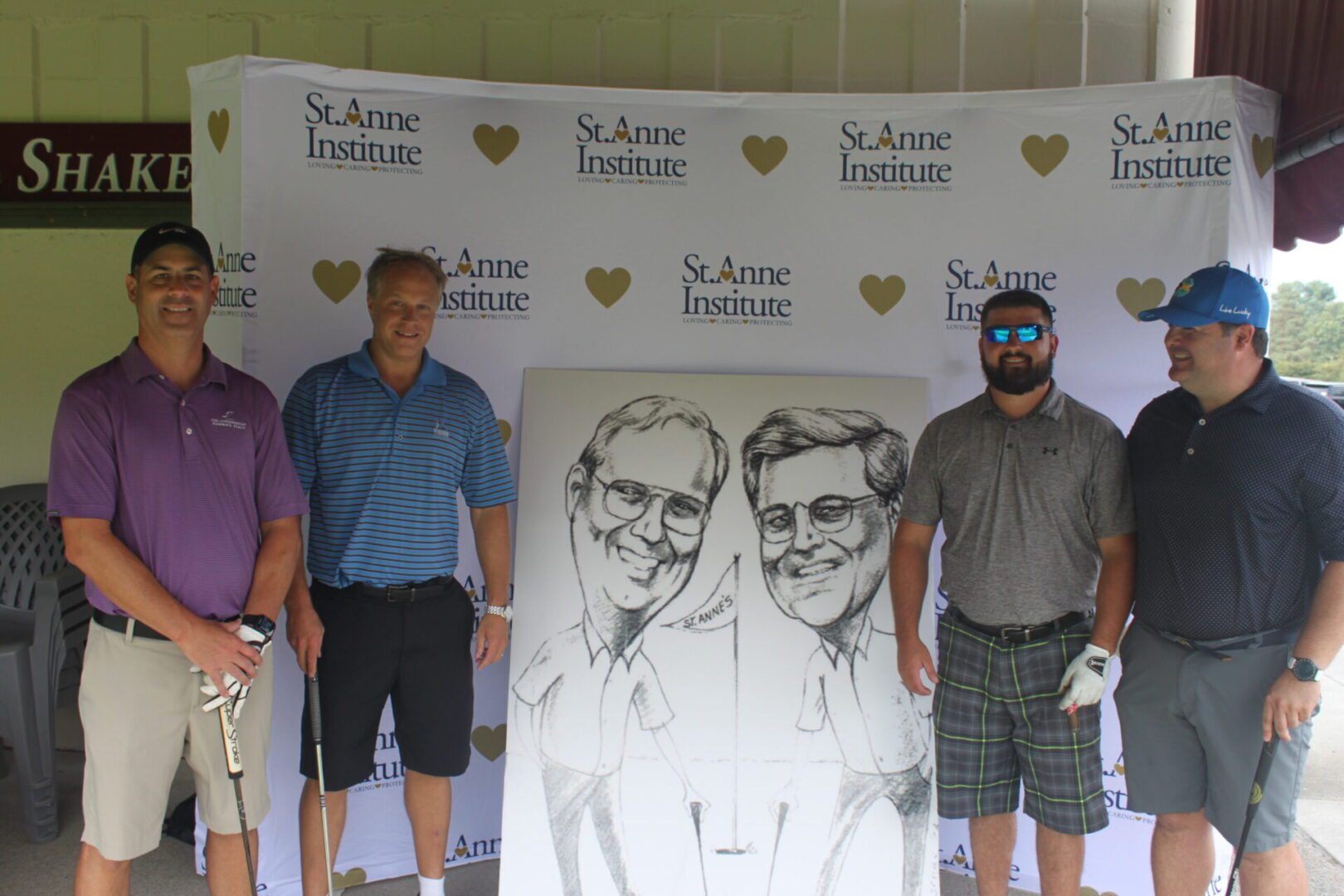 A group of men posing for a photo with a caricature.