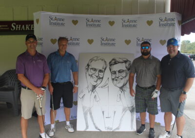 A group of men posing for a photo with a caricature.