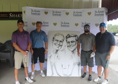 A group of men posing for a photo with a caricature.