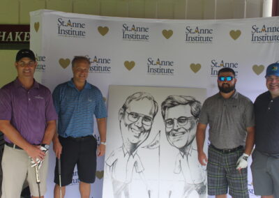 A group of men posing for a photo with a caricature.