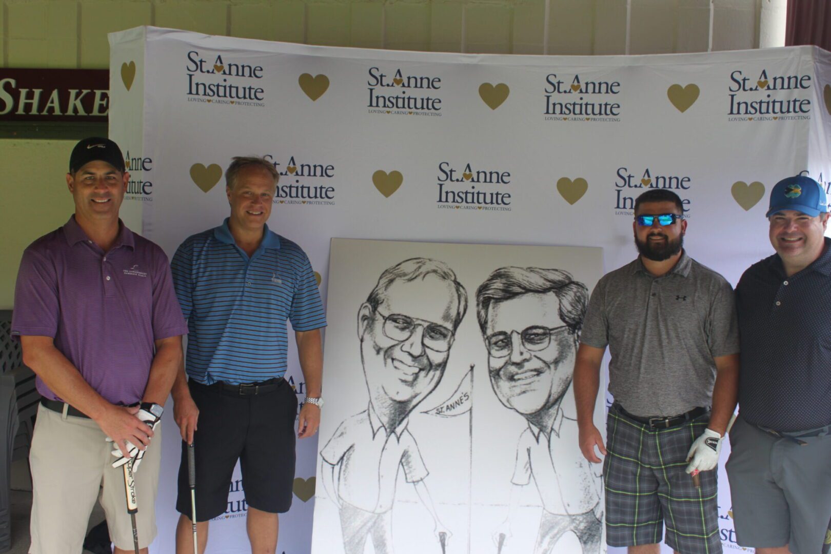 A group of men posing for a photo with a caricature.