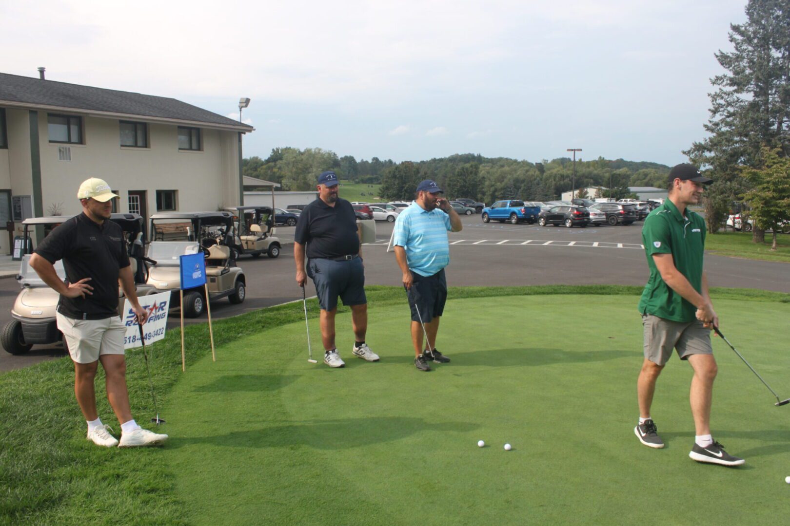 A group of men playing golf in a parking lot.