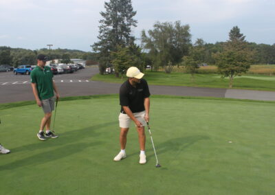 A group of people on a golf course.