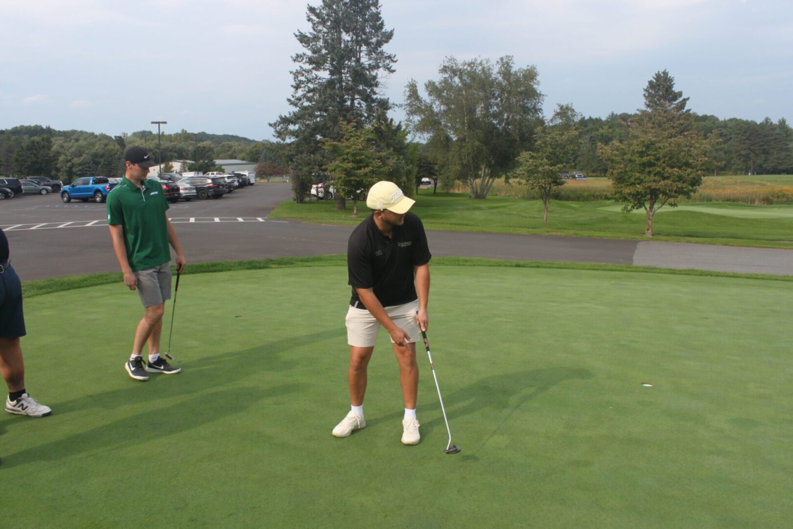 A group of people on a golf course.