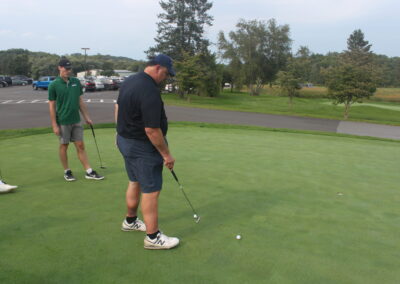 A group of people on a golf course.