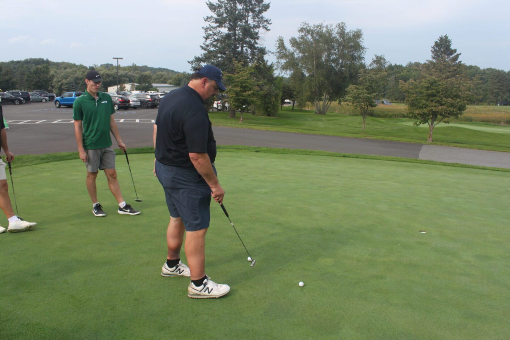 A group of people on a golf course.