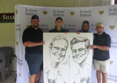 A group of men posing with a caricature.