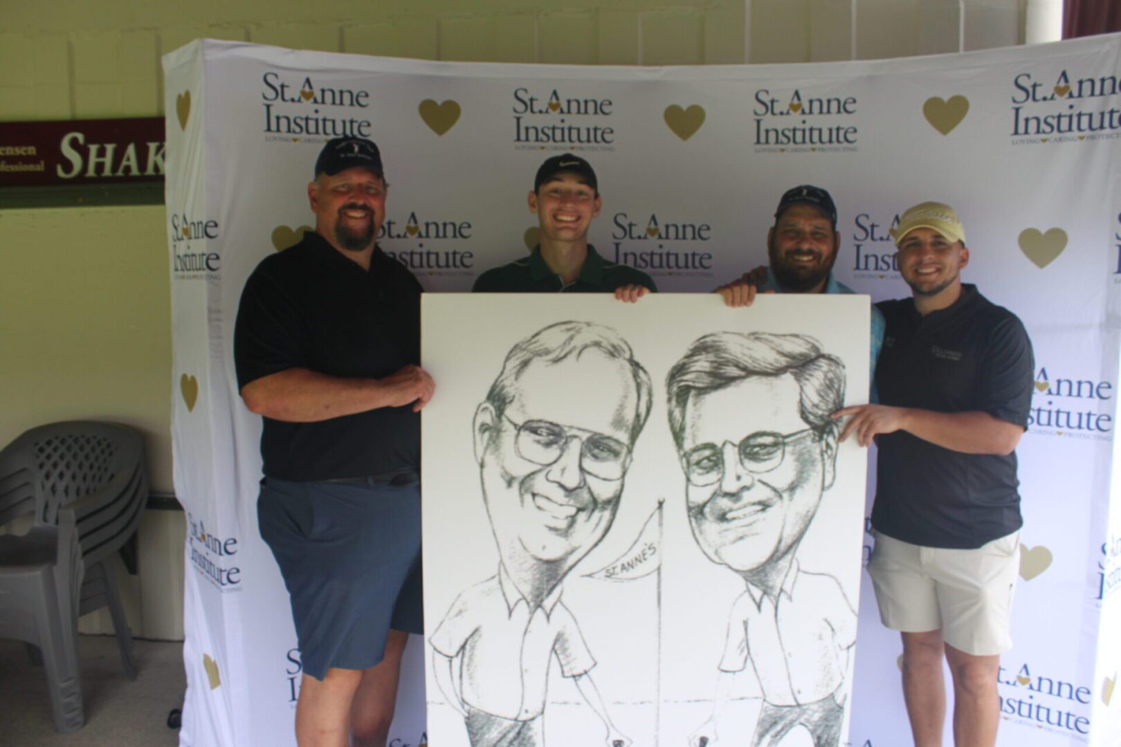 A group of men posing with a caricature.