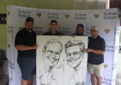 A group of men posing with a caricature.