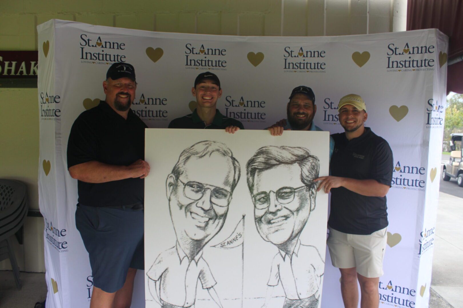 A group of men posing with a caricature.