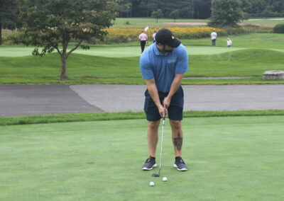 A man is putting a ball on a golf course.