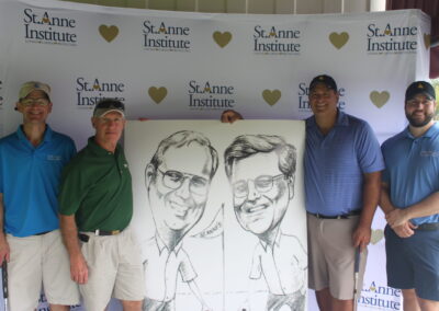 A group of men posing for a photo with a caricature.