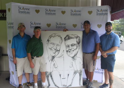 A group of men posing with a caricature.