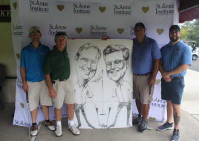 A group of men posing with a caricature.