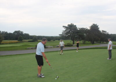 A group of people on a golf course.