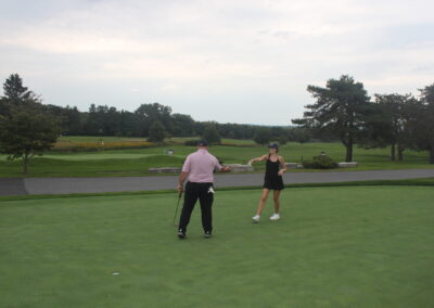 A group of people on a golf course.