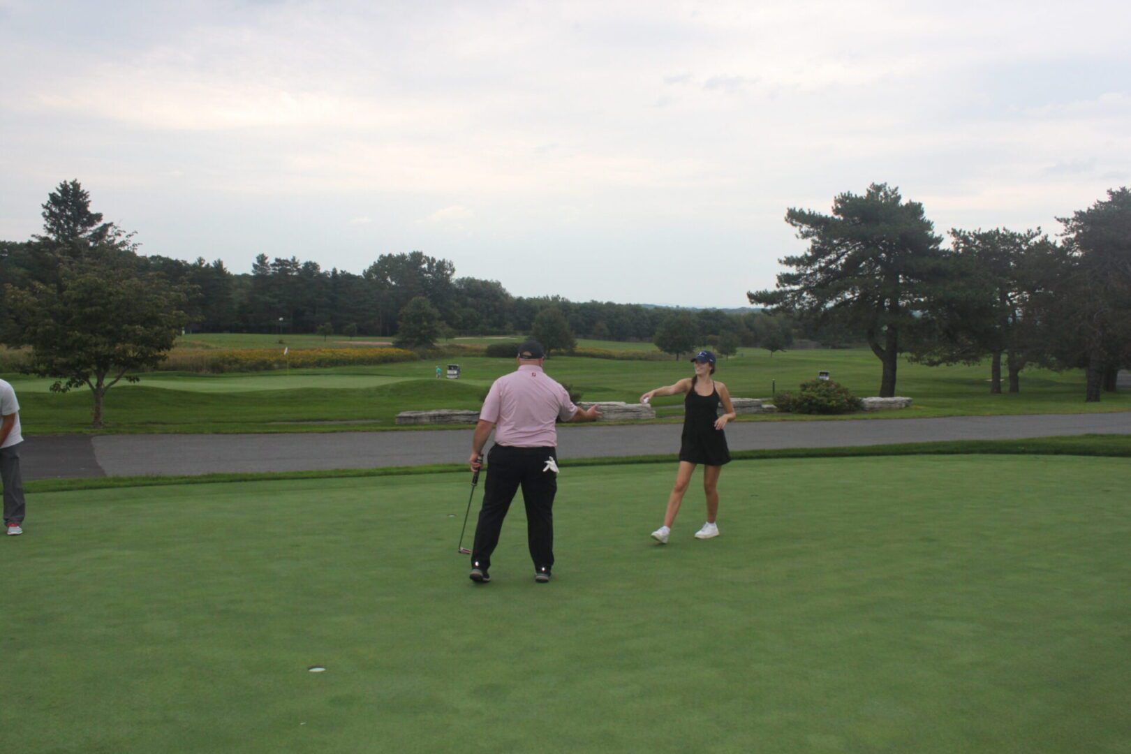 A group of people on a golf course.