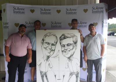 A group of men posing with a caricature.