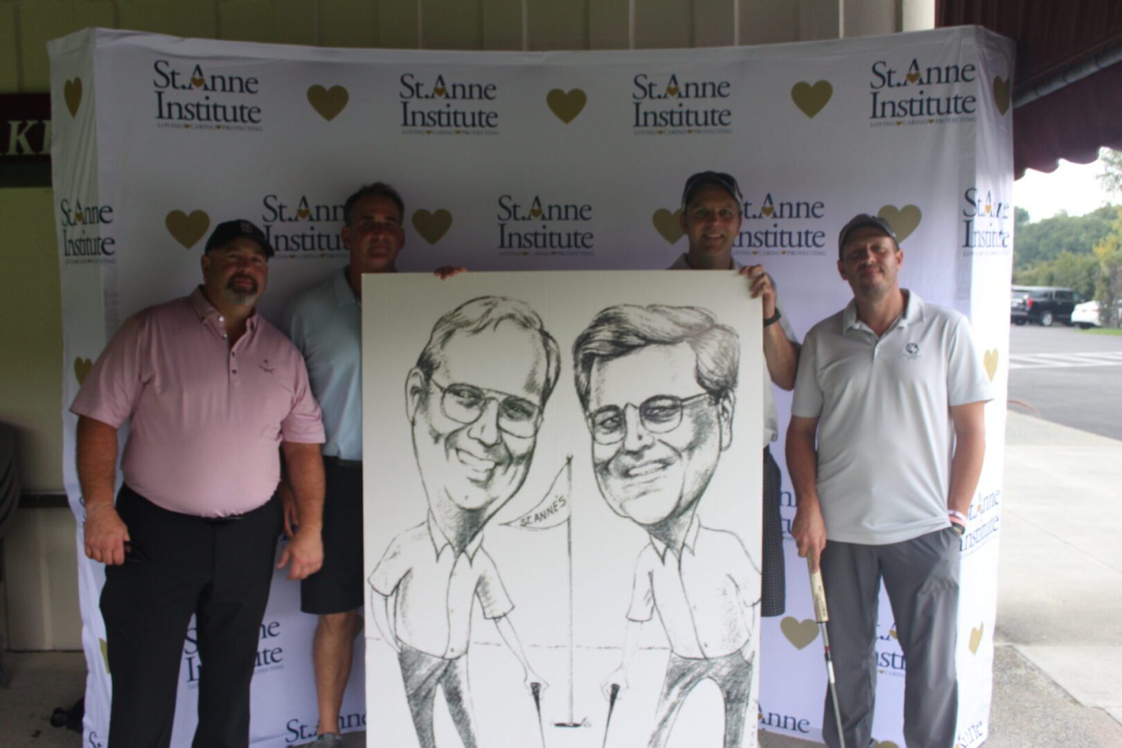 A group of men posing with a caricature.