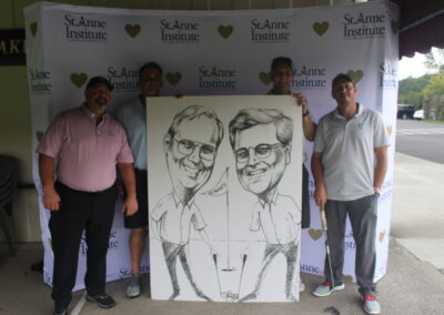 A group of men posing with a caricature.