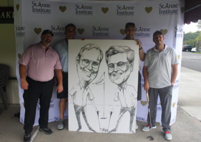 A group of men posing with a caricature.