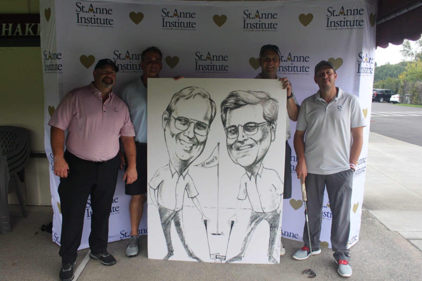 A group of men posing with a caricature.