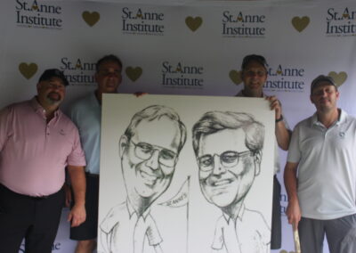 A group of men posing with a caricature.