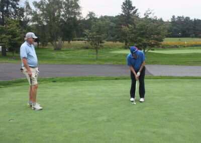 Two men on a golf course.