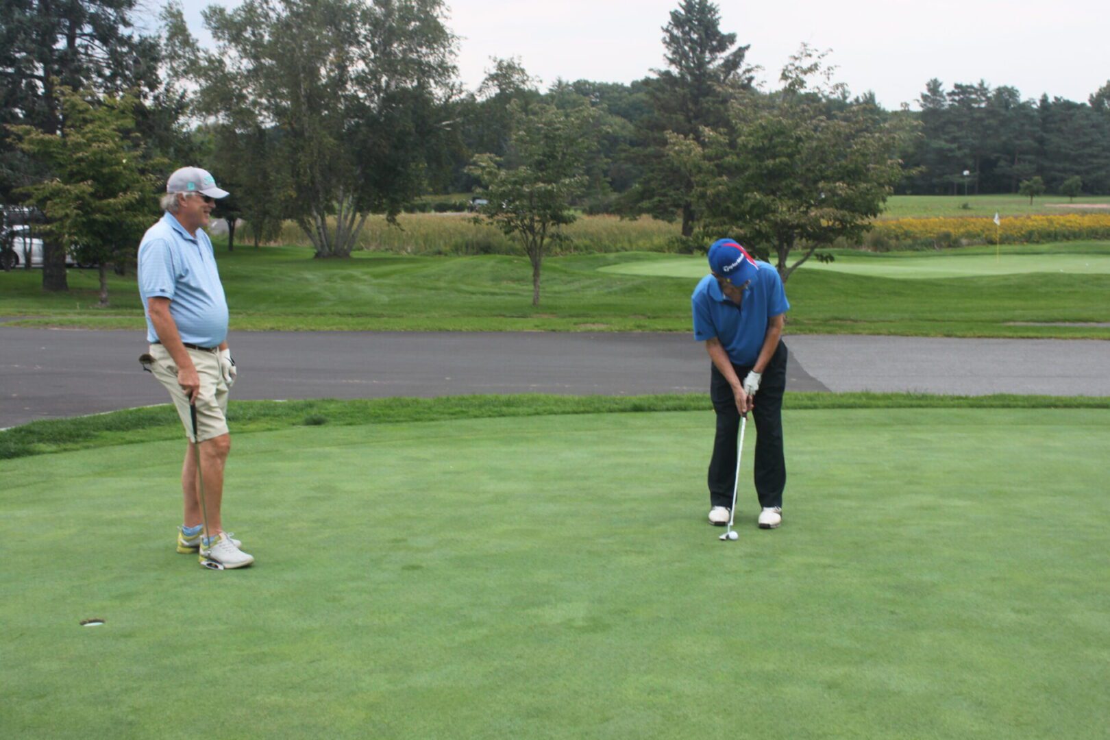 Two men on a golf course.