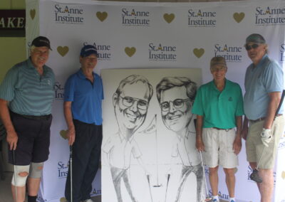 A group of people posing for a photo with a caricature.