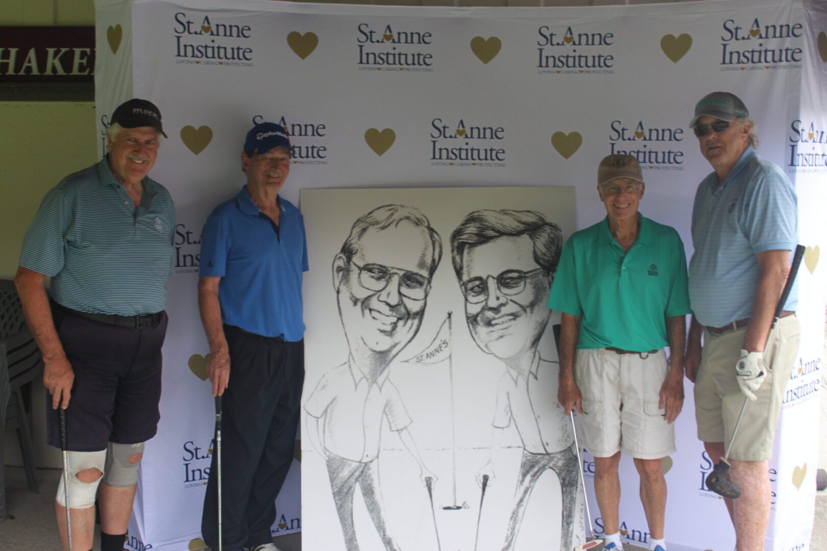 A group of people posing for a photo with a caricature.