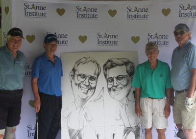 A group of men posing for a photo with a caricature.