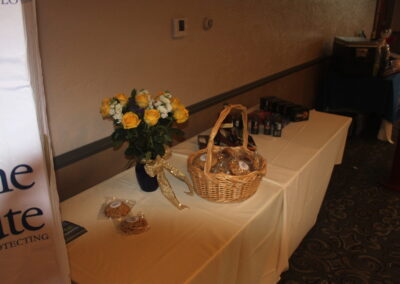 A table with a basket of cookies and flowers.