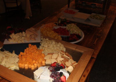 A table with a lot of cheese and fruit on it.