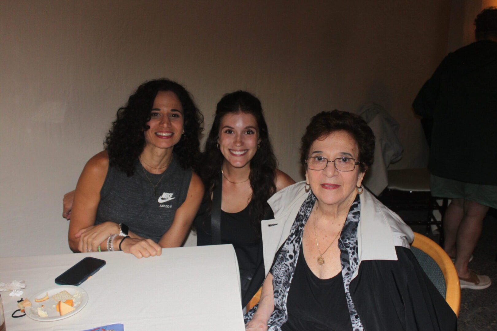 Three women sitting at a table.