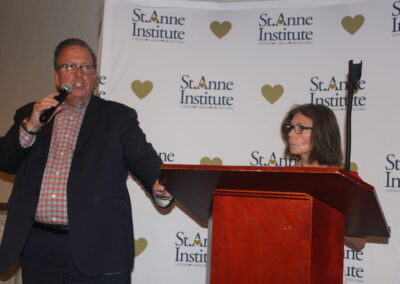 A man and a woman standing at a podium.