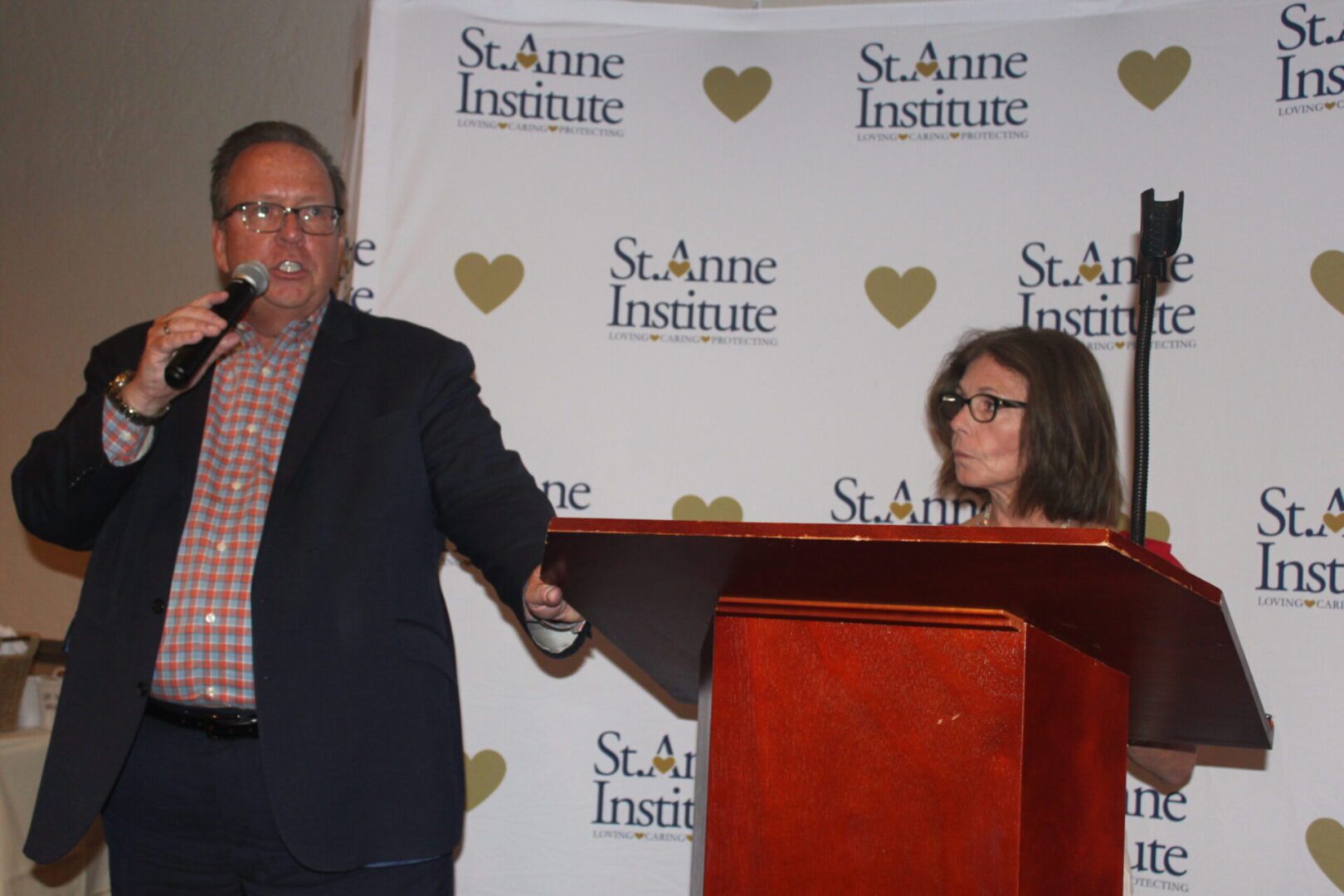 A man and a woman standing at a podium.