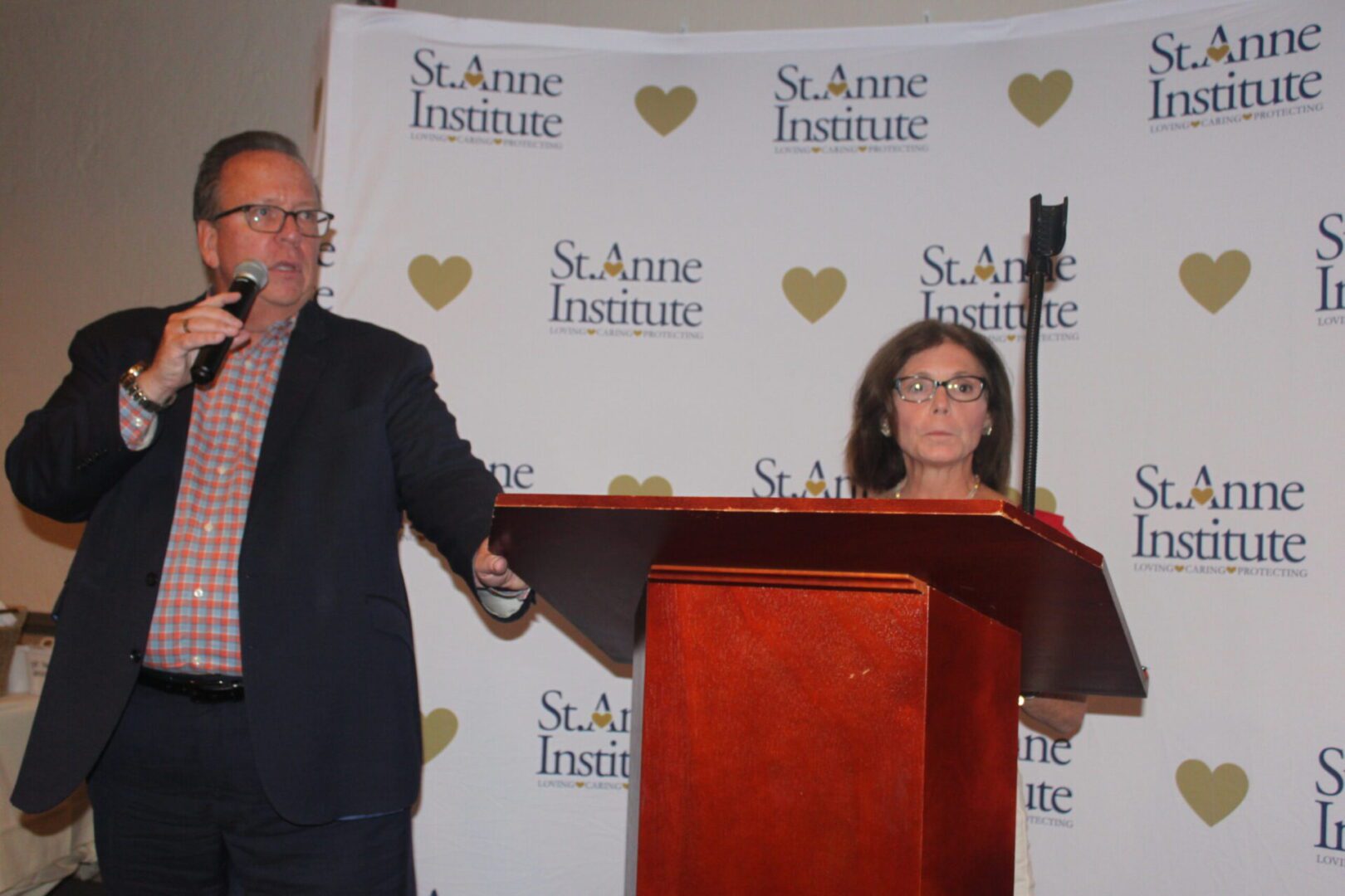 A man and a woman standing at a podium.