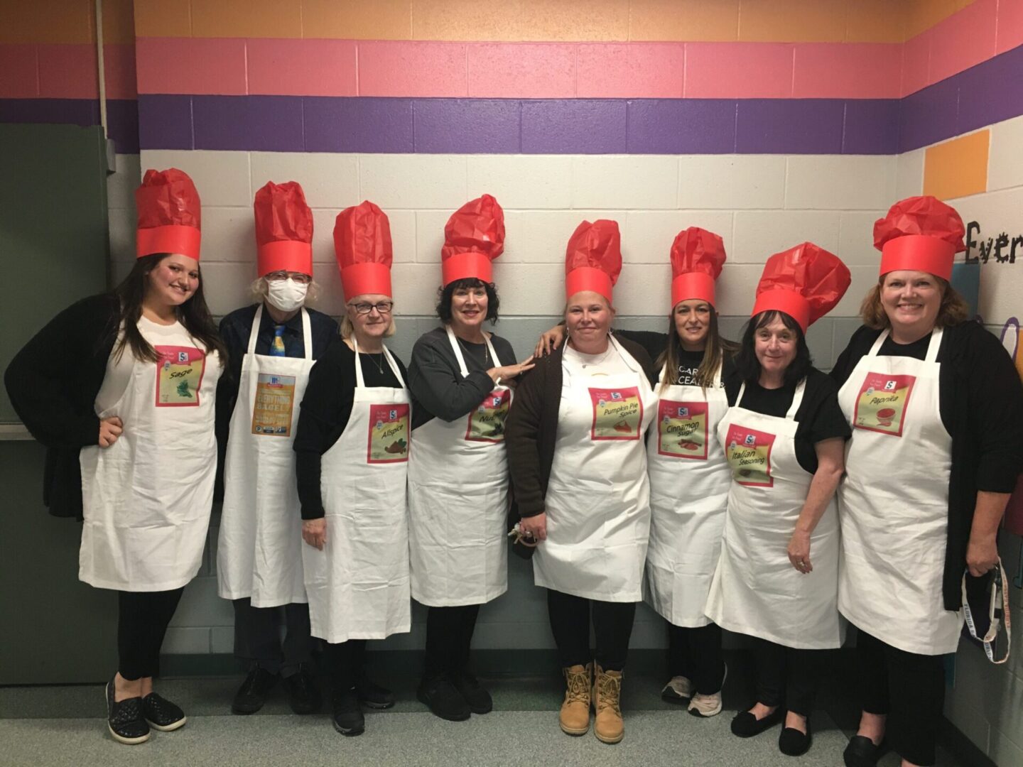 People wearing red chef hats at a place