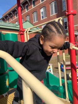 A kid wearing black jackets