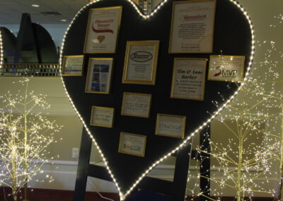 A heart shaped display with a lot of pictures on it.