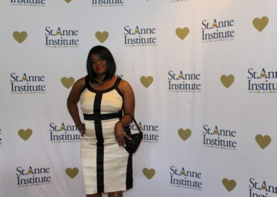 A woman in a black and white dress posing for a photo.