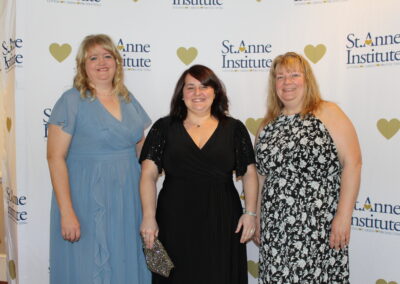 Three women posing for a picture.