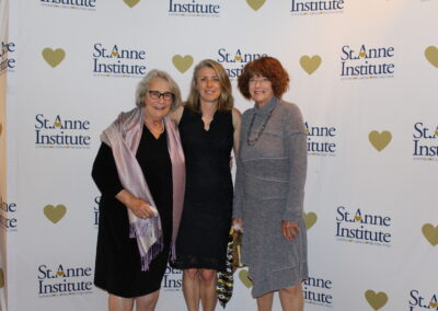 Three women posing for a picture.